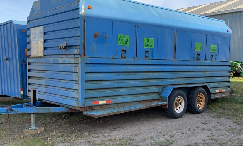 Image is of a light blue assorted recycling trailer.